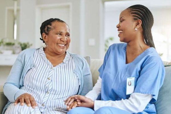 senior-woman-nurse-laughing-together-support-healthcare-happiness-retirement-home-black-person-patient-caregiver-holding-hands-trust-elderly-care-help-wellness_590464-185992